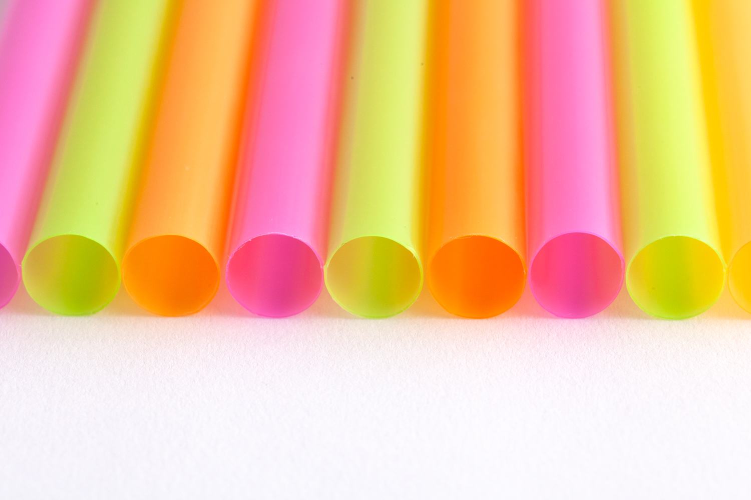 closeup of multi-coloured straws lined up side by side