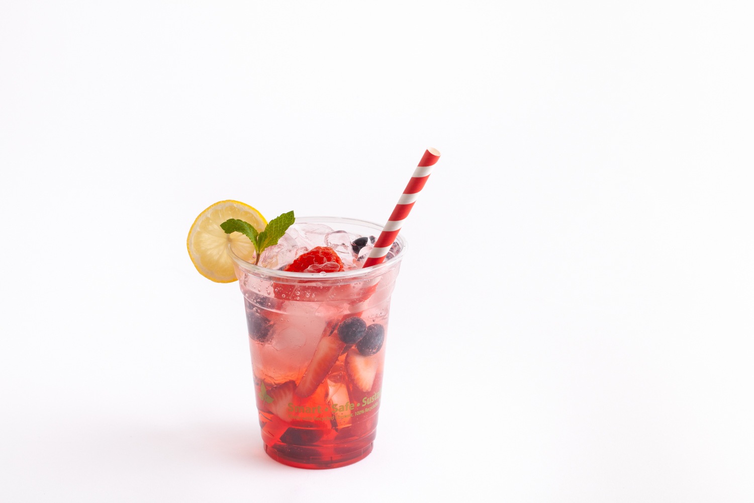 red cocktail straw in clear drinking cup filled with fruit water