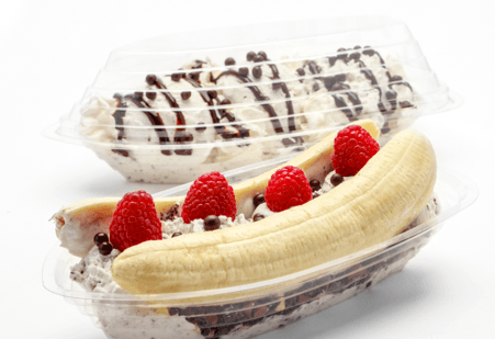 2 banana splits in banana split boats, 1 with lid, 1 without