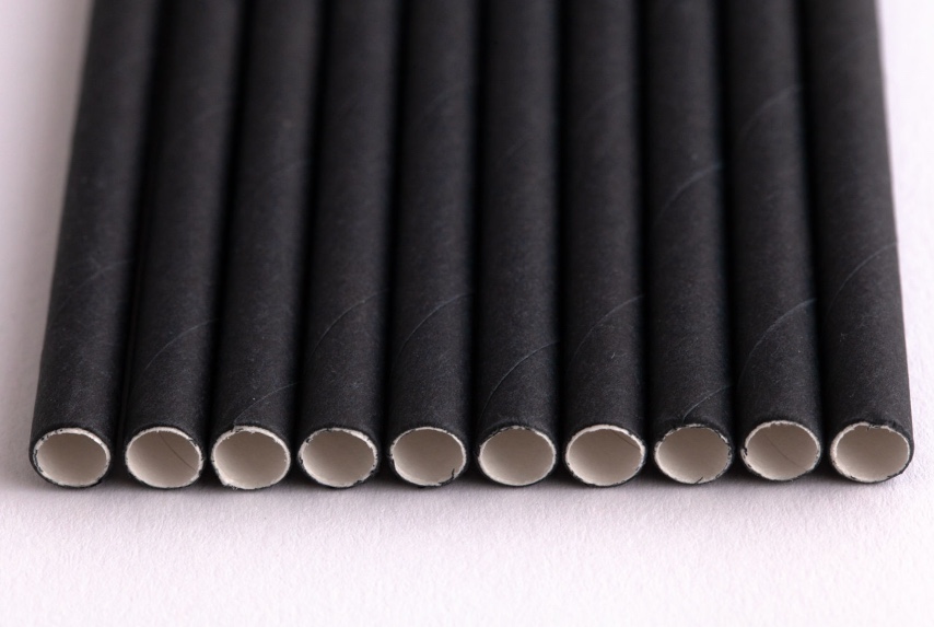 line of black paper straws