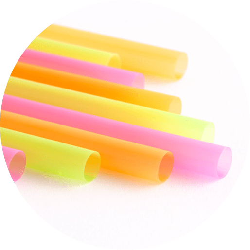 group of thick plastic straws in a variety of neon colours
