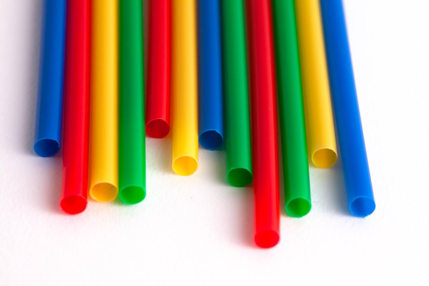 multi-coloured cocktail straws lined up side by side