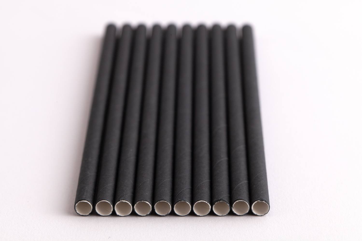 black paper straws lined up side by side